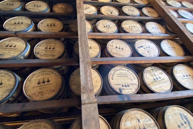 Rows of wooden bourbon barrels.