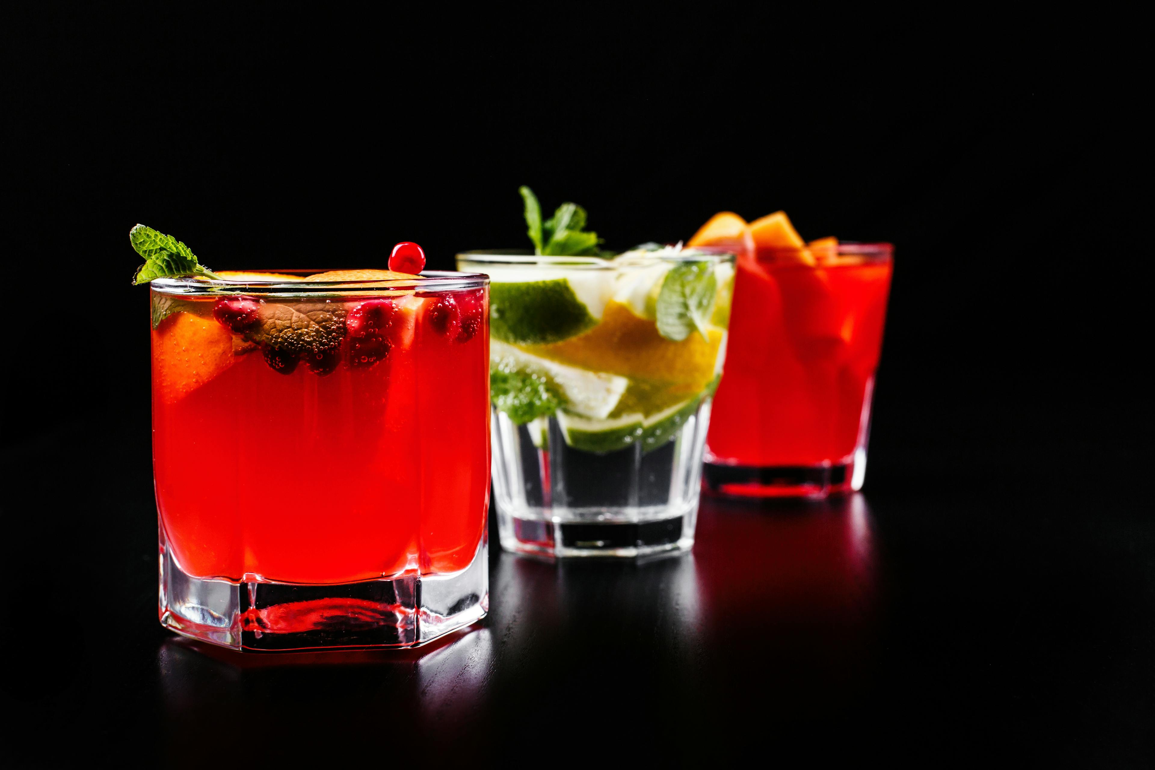 Various drinks are against a dark background.
