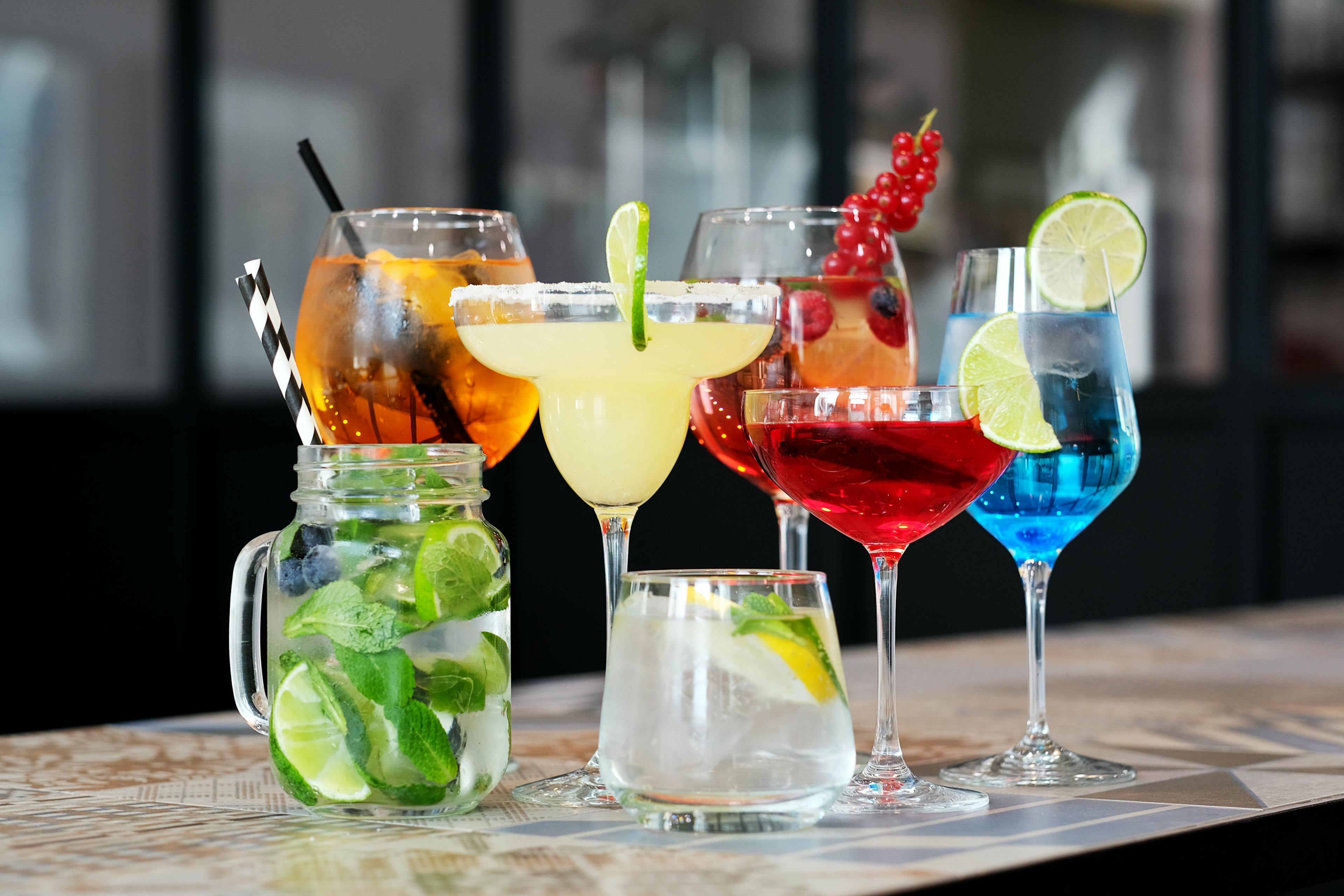 Colorful cocktails arranged on the counter.