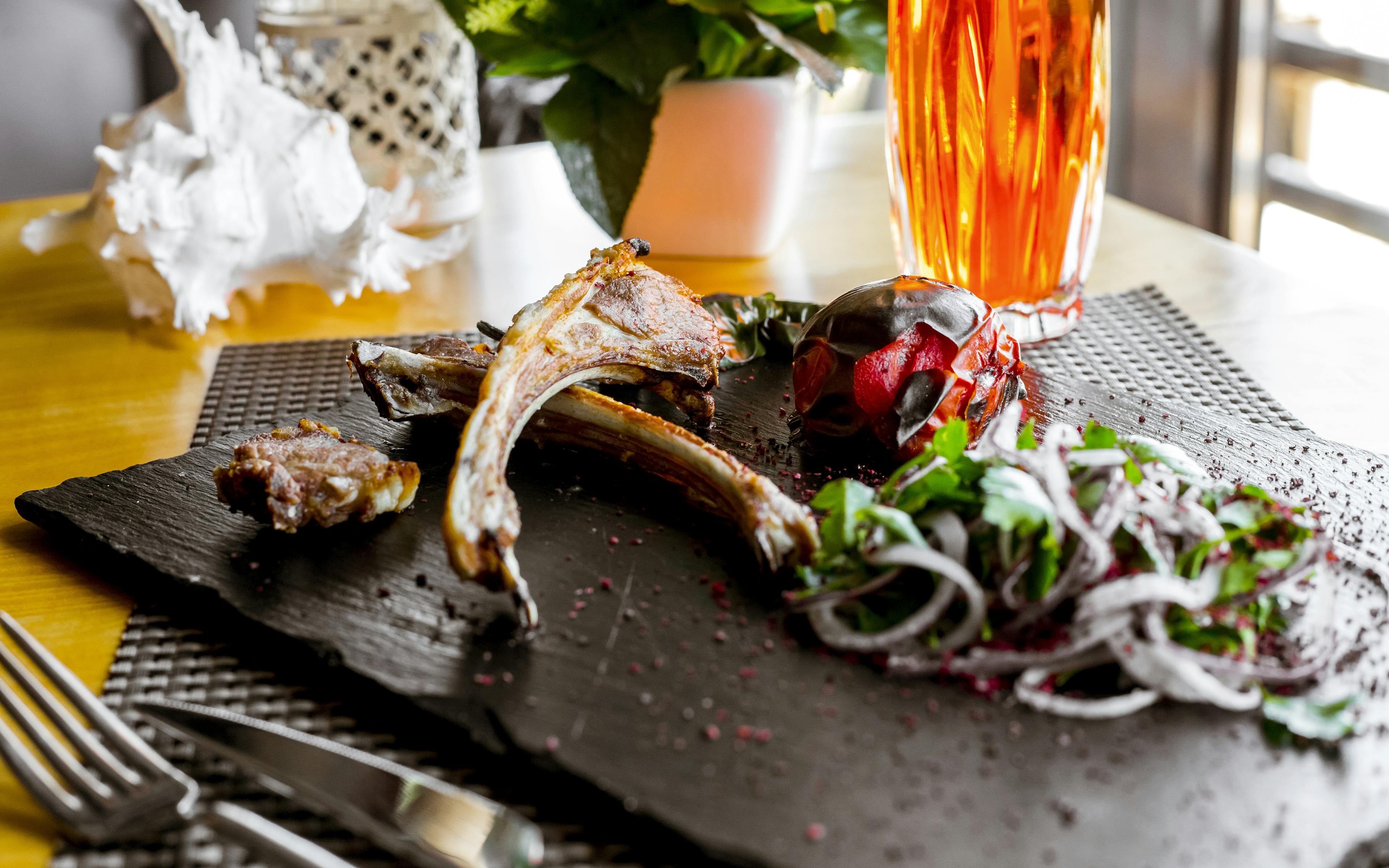 A gourmet dish with intricate garnishes, elegantly presented on a slate.