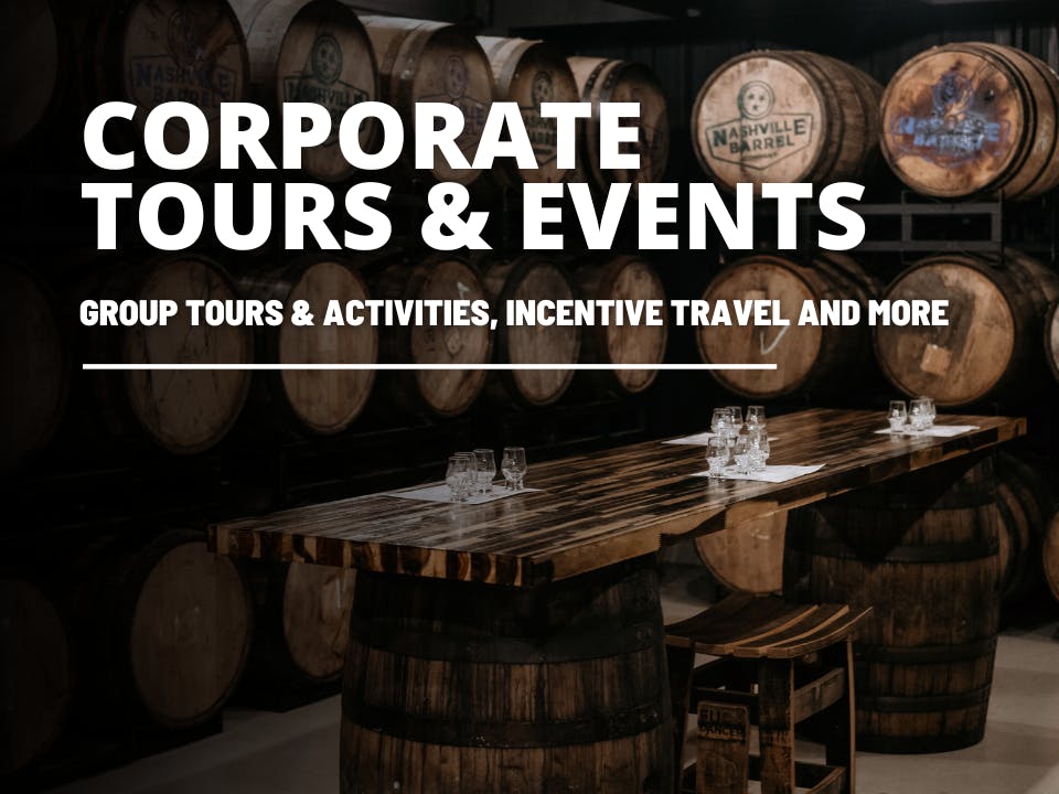 A scene titled "Corporate Tours and Events" featuring a rustic setting with a long wooden table, ideal for gatherings, and a stack of wooden bourbon barrels in the background.