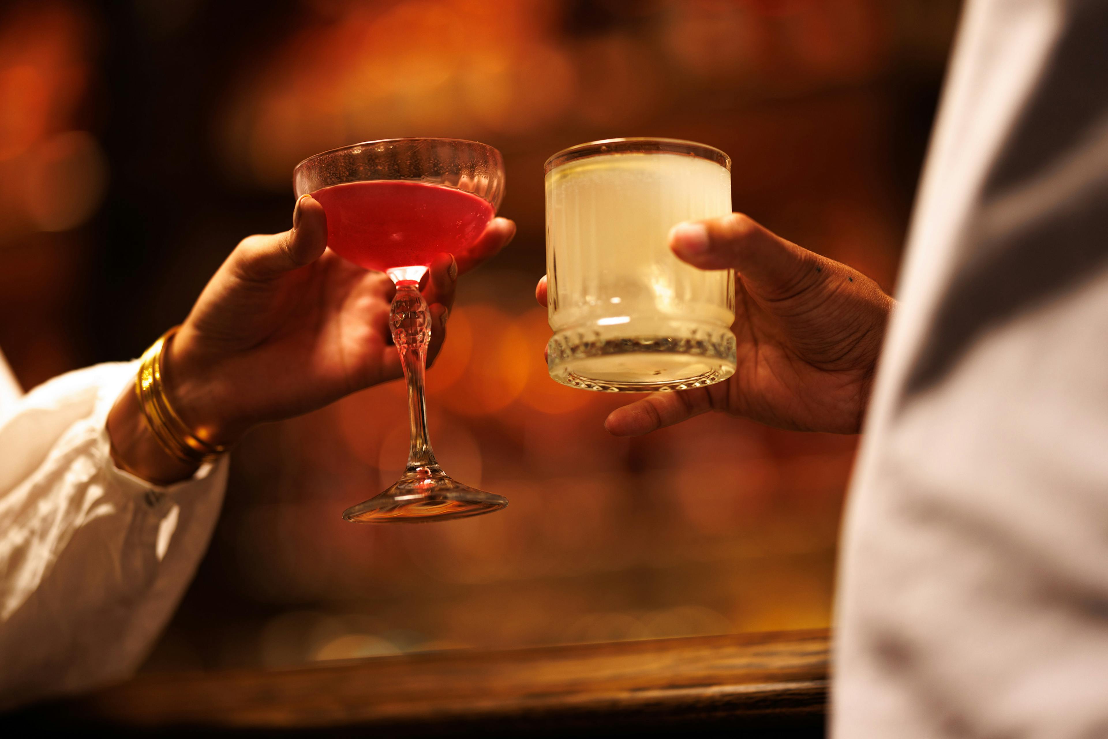 A couple enjoying holiday cocktails at the 2025 Holiday Hop by Mint Julep Experiences