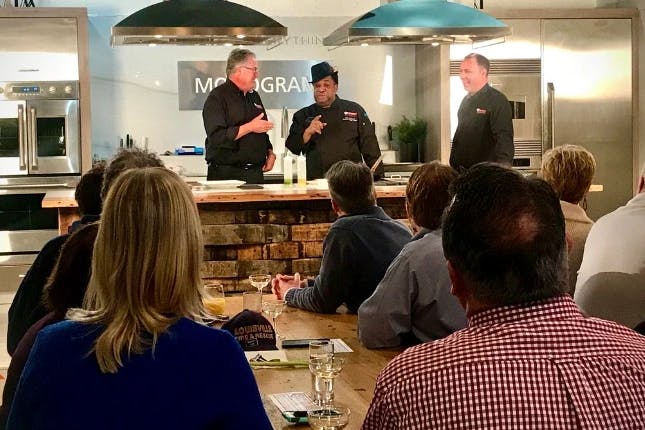 Behind the scenes of the "Secrets of Bluegrass Chefs," with the audience watching the chefs in action.