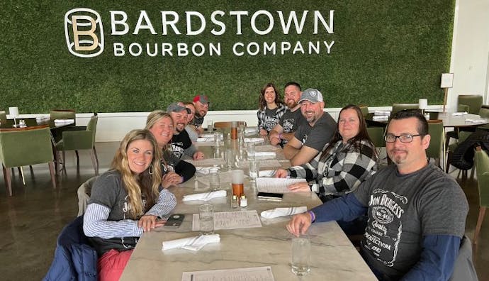 Tourists seated at a table at Bardstown Bourbon Company.