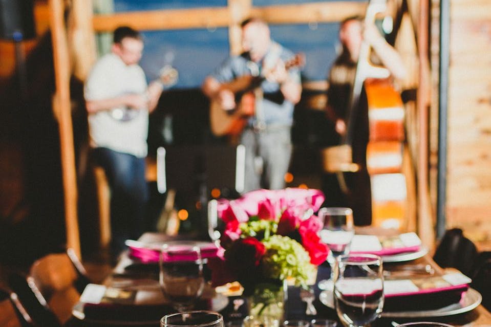 A set dining table with a band playing music in the background.