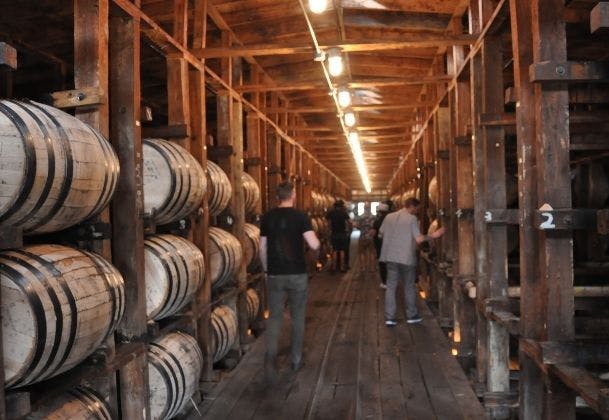 A group of people touring Jack Daniel's barrelhouse.