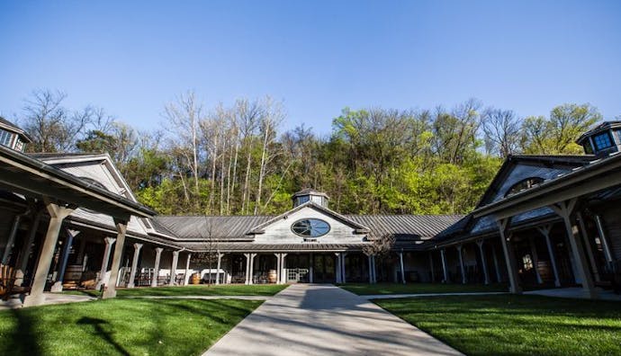 An exterior view of the Jack Daniel's Visitor Center, showcasing its welcoming entrance and rustic design.