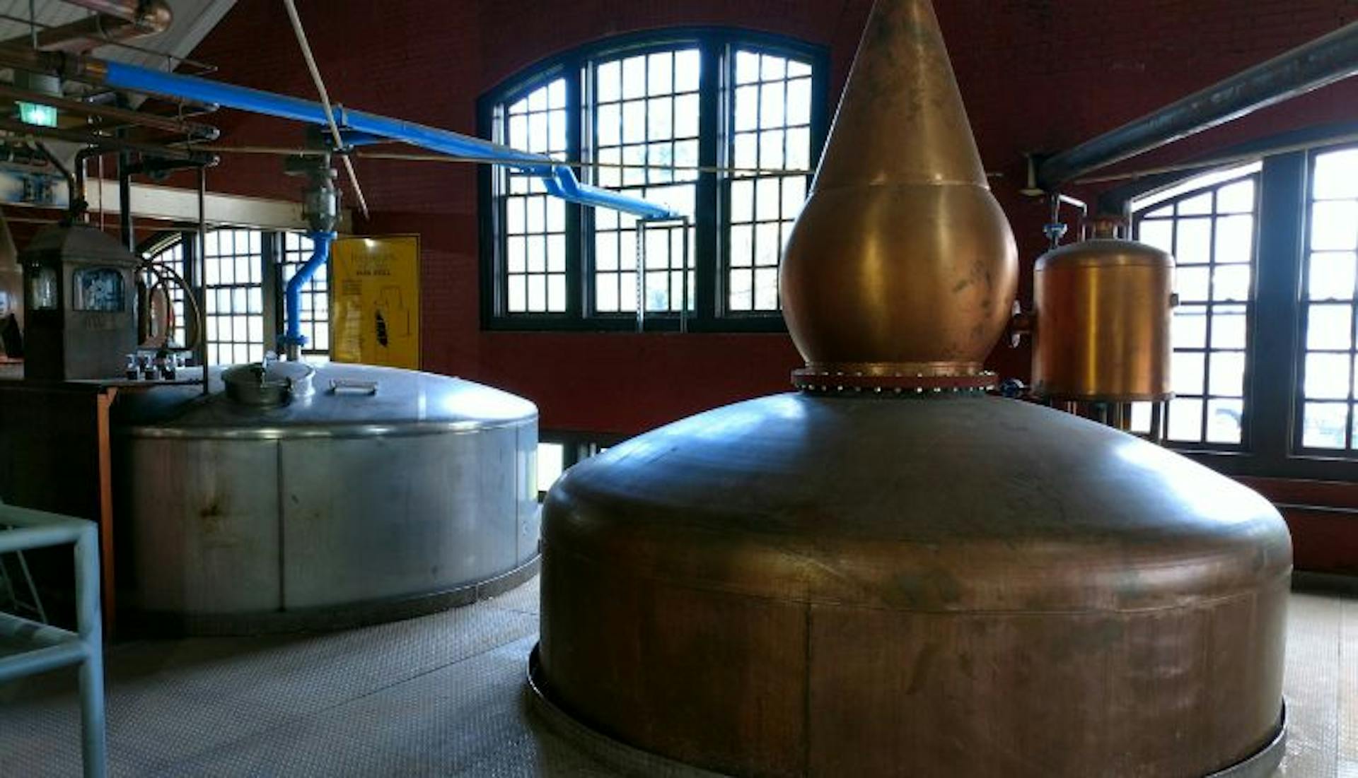 An industrial copper still in a distillery.