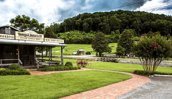 Exterior view of Cascade Hollow Distilling Co., surrounded by lush greenery.