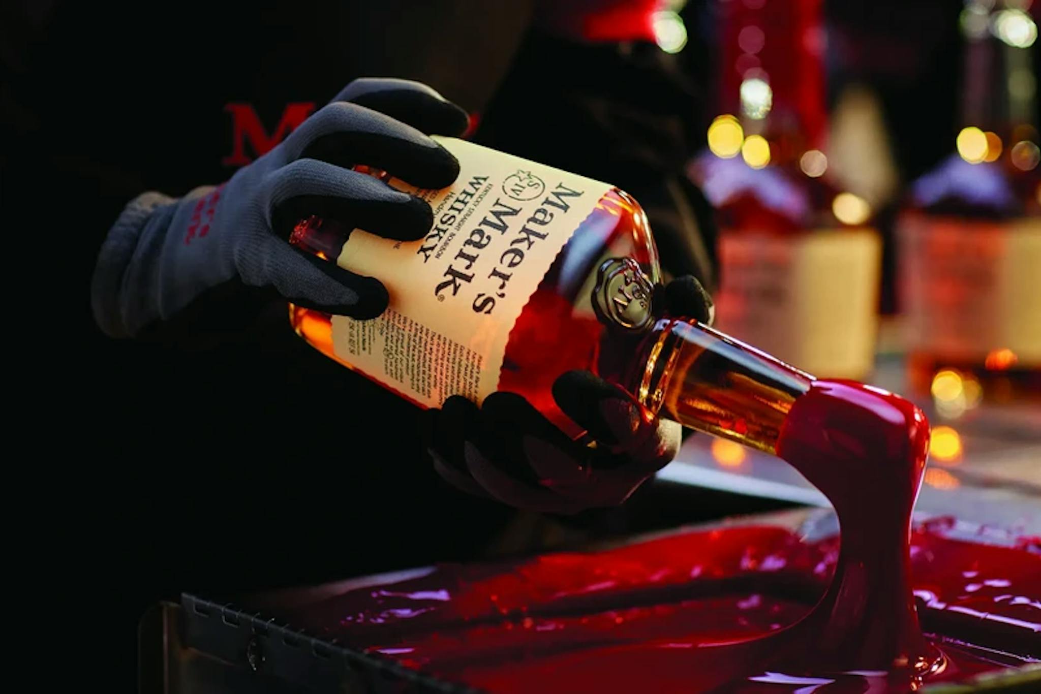 Customers dip Maker's Mark bottles into red wax