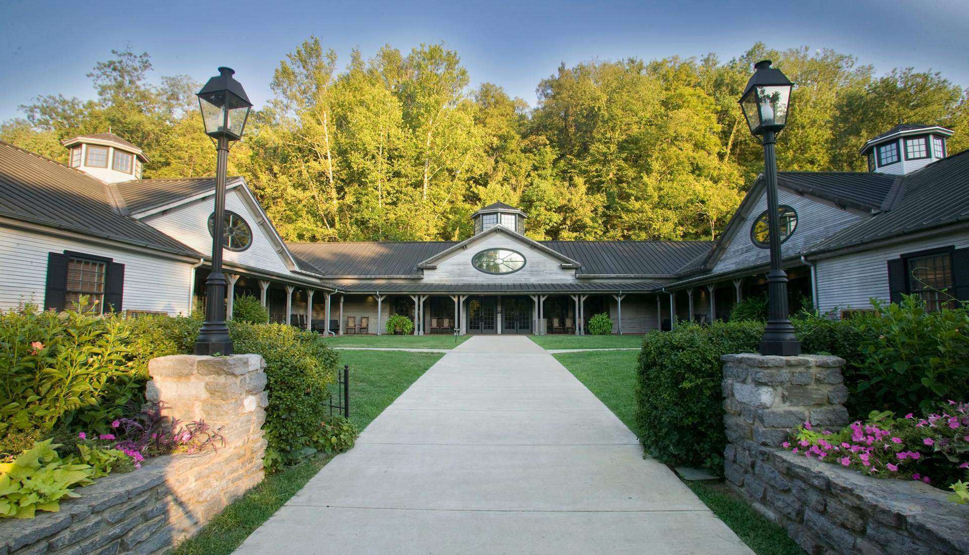An exterior view of the Jack Daniel's Visitor Center, showcasing its welcoming entrance and rustic design.