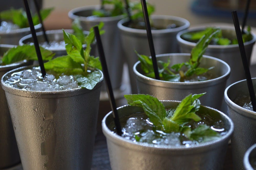 Mint Julep drinks served in stainless steel cups.
