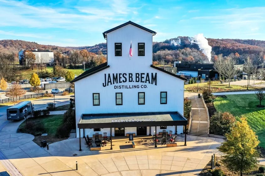 An exterior view of James B. Beam Distilling Co., showcasing the distillery buildings and signage.