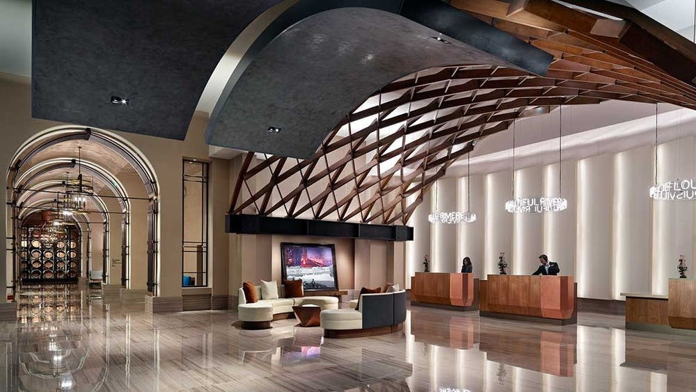 Elegant reception area of the Omni Louisville Hotel featuring a modern front desk and inviting lighting.