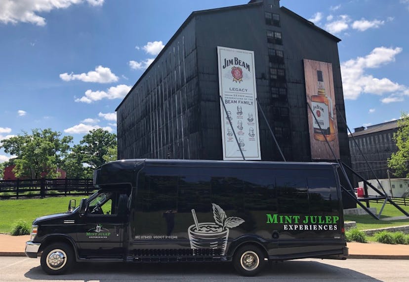 A Mint Julep Experiences luxury transportation parked in front of Jim Beam Distillery 