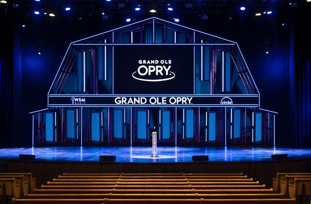The Grand Ole Opry stage illuminated in vibrant blue lights.