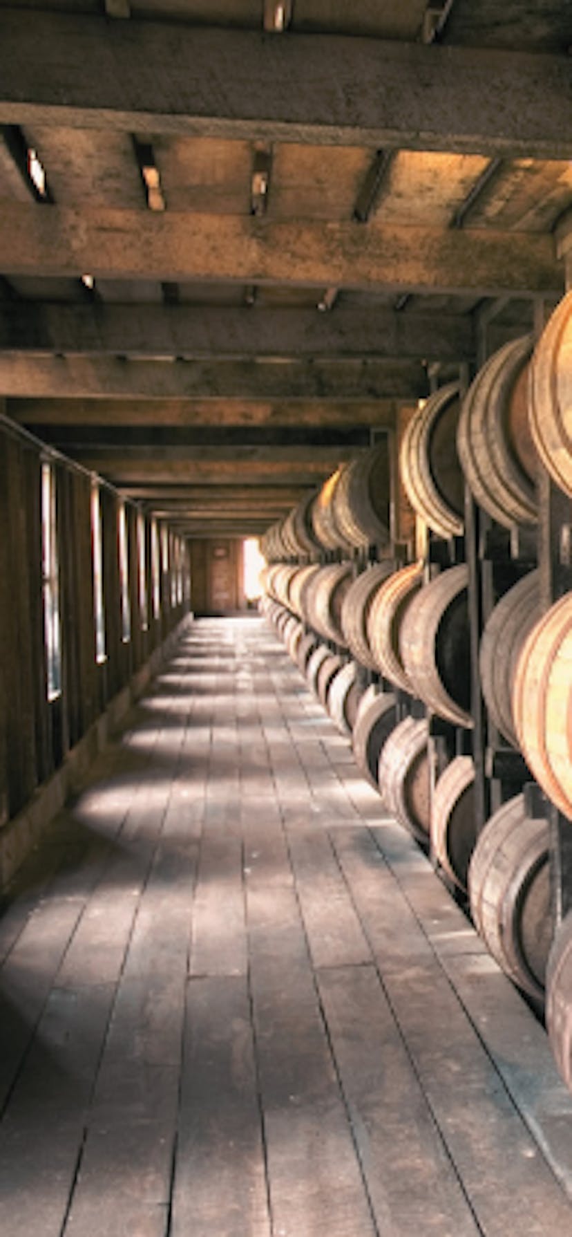 bourbon barrels age in a rickhouse
