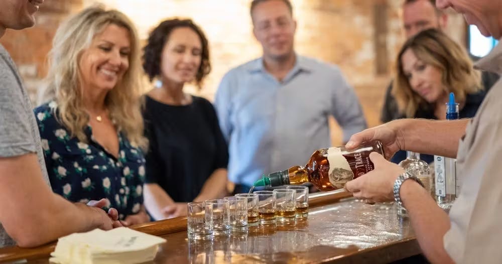 A group of people participating in a bourbon tasting session.