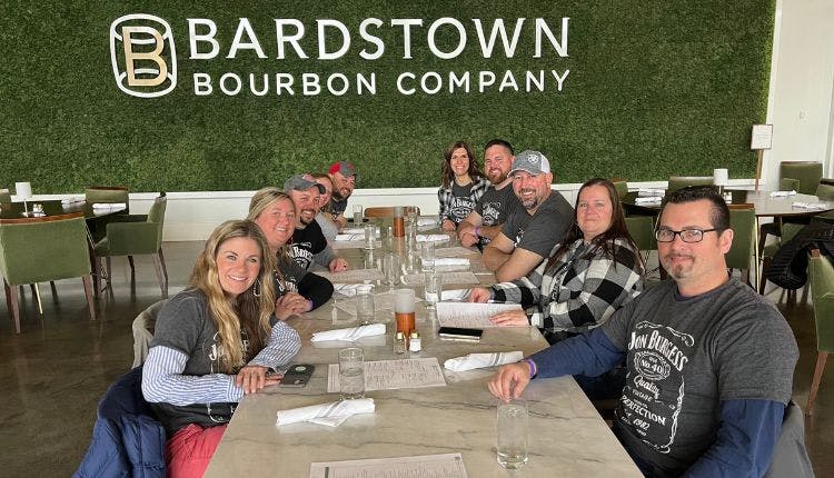 Tourists seated at tables at Bardstown Bourbon Company, enjoying their visit.