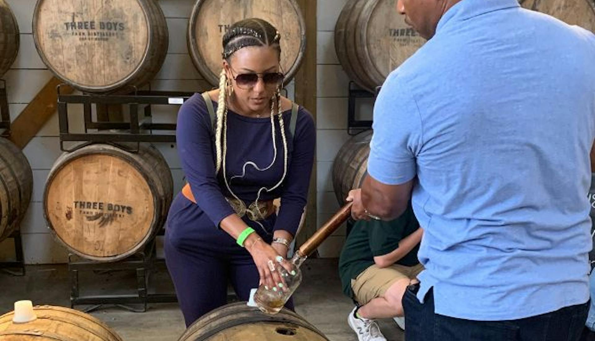 A woman engaged in a bourbon thieving experience by Mint Julep Eperiences.
