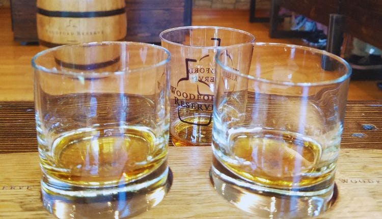 Three tasting glasse with Woodford Reserve Bourbon, neatly arranged for sampling.