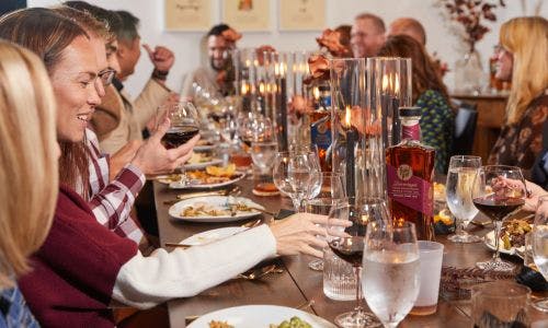 People seated at a table, enjoying an elevated dining experience with elegantly presented dishes and a refined atmosphere.