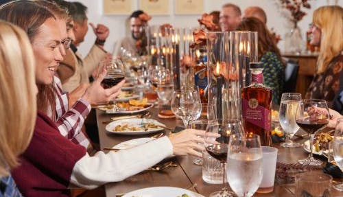 People seated at a table, enjoying an elevated dining experience with elegantly presented dishes and a refined atmosphere.