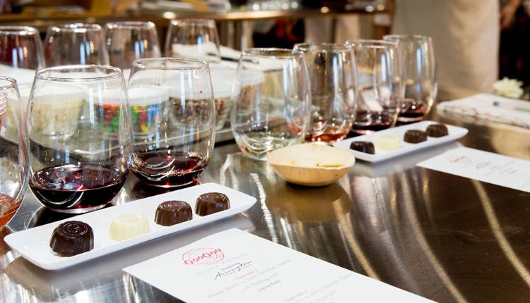 Glasses of wine paired with artisanal chocolates set up for a wine tasting experience at Goo Goo Chocolate Co.