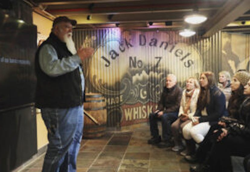 A tour leader speaking to an attentive group at the Jack Daniel's Distillery in Lynchburg, Tennessee.