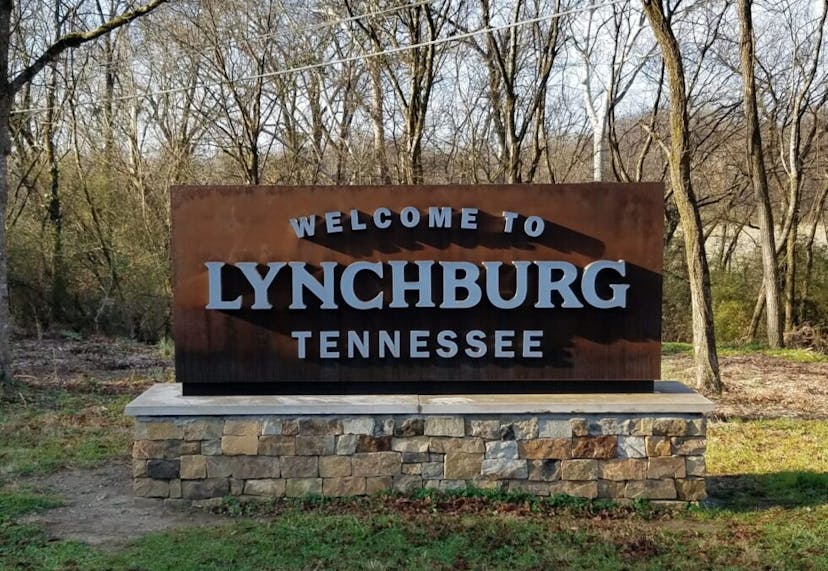 A sign reading "Welcome to Lynchburg, Tennessee," marking the entrance to the historic town known for its whiskey heritage.
