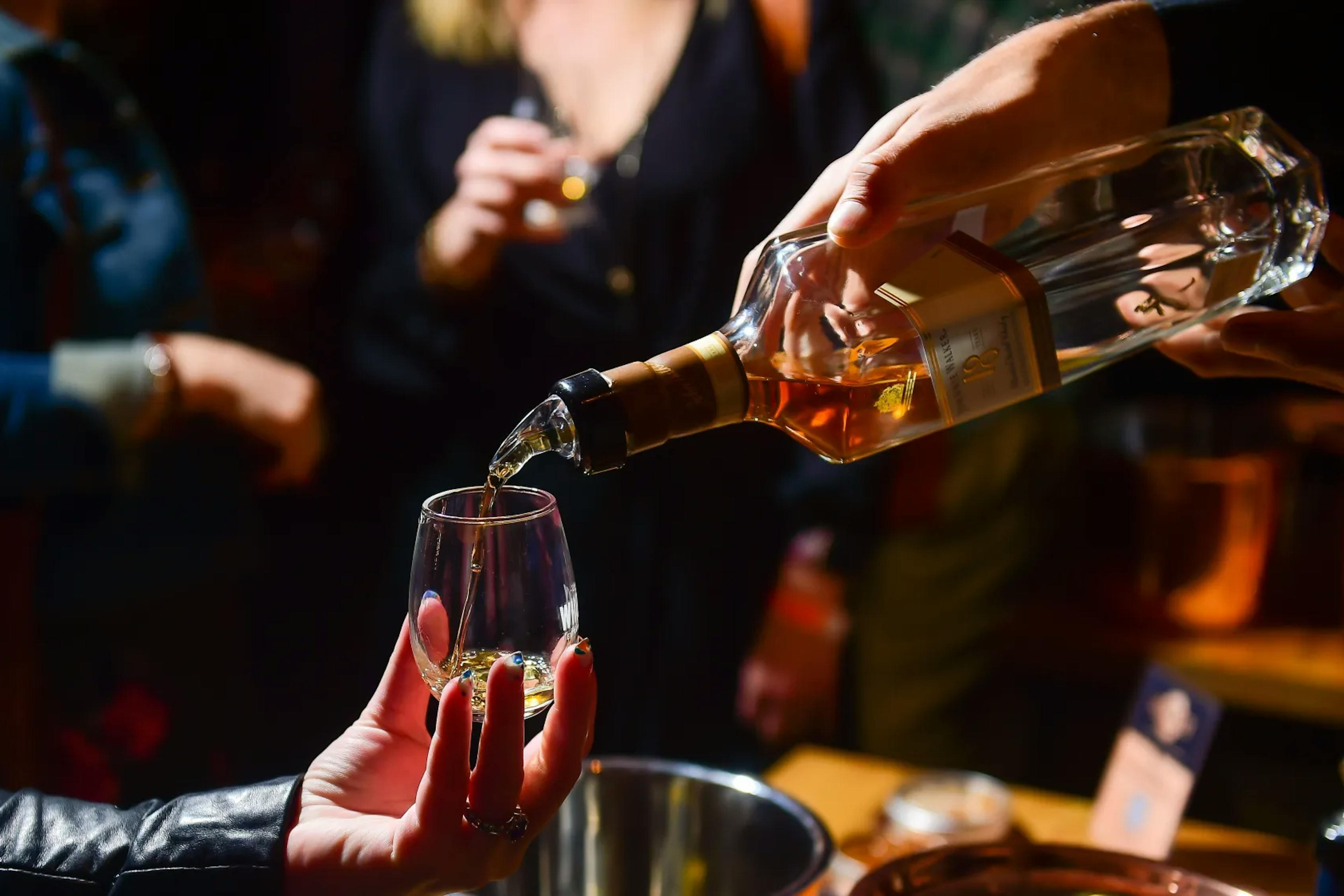 Rare Buffalo Trace Bourbon is Poured into a glass at the KBCA bourbon auction