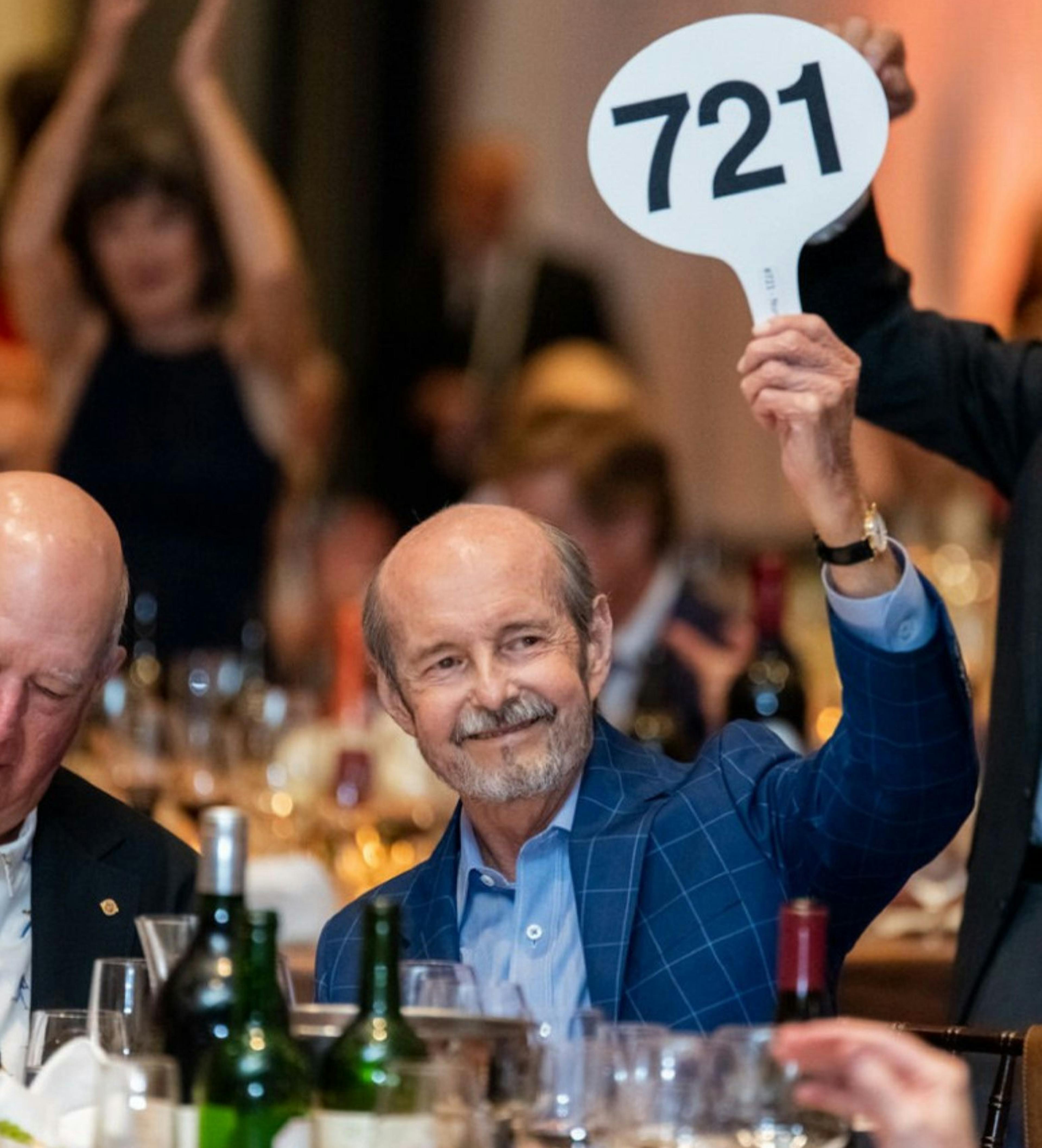 A man in a suit bids on an entire barrel of rare bourbon from buffalo trace