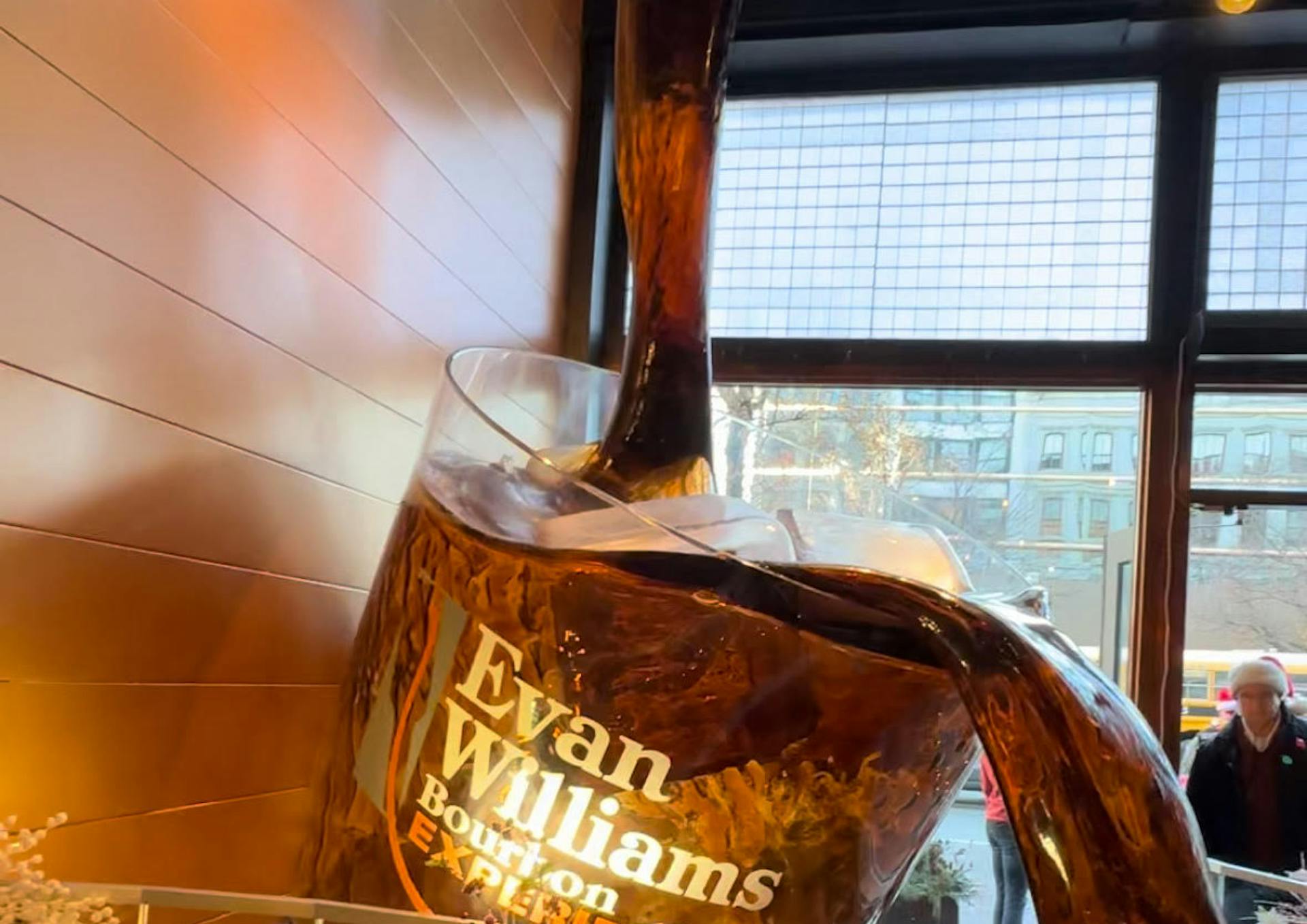 a large whiskey glass sculpture at the evan williams bourbon experience