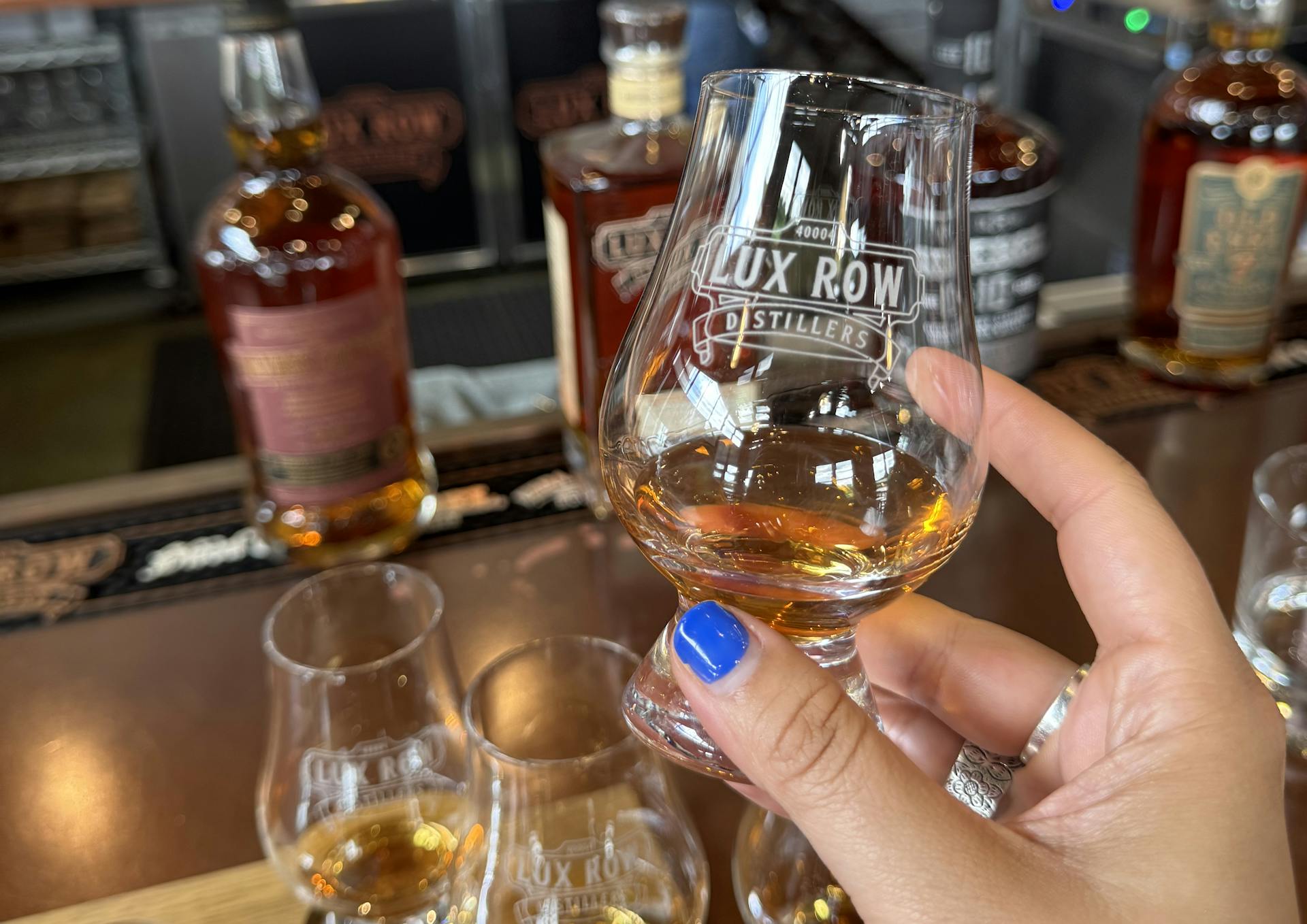 A glass of a pour served in a lux row tasting flight