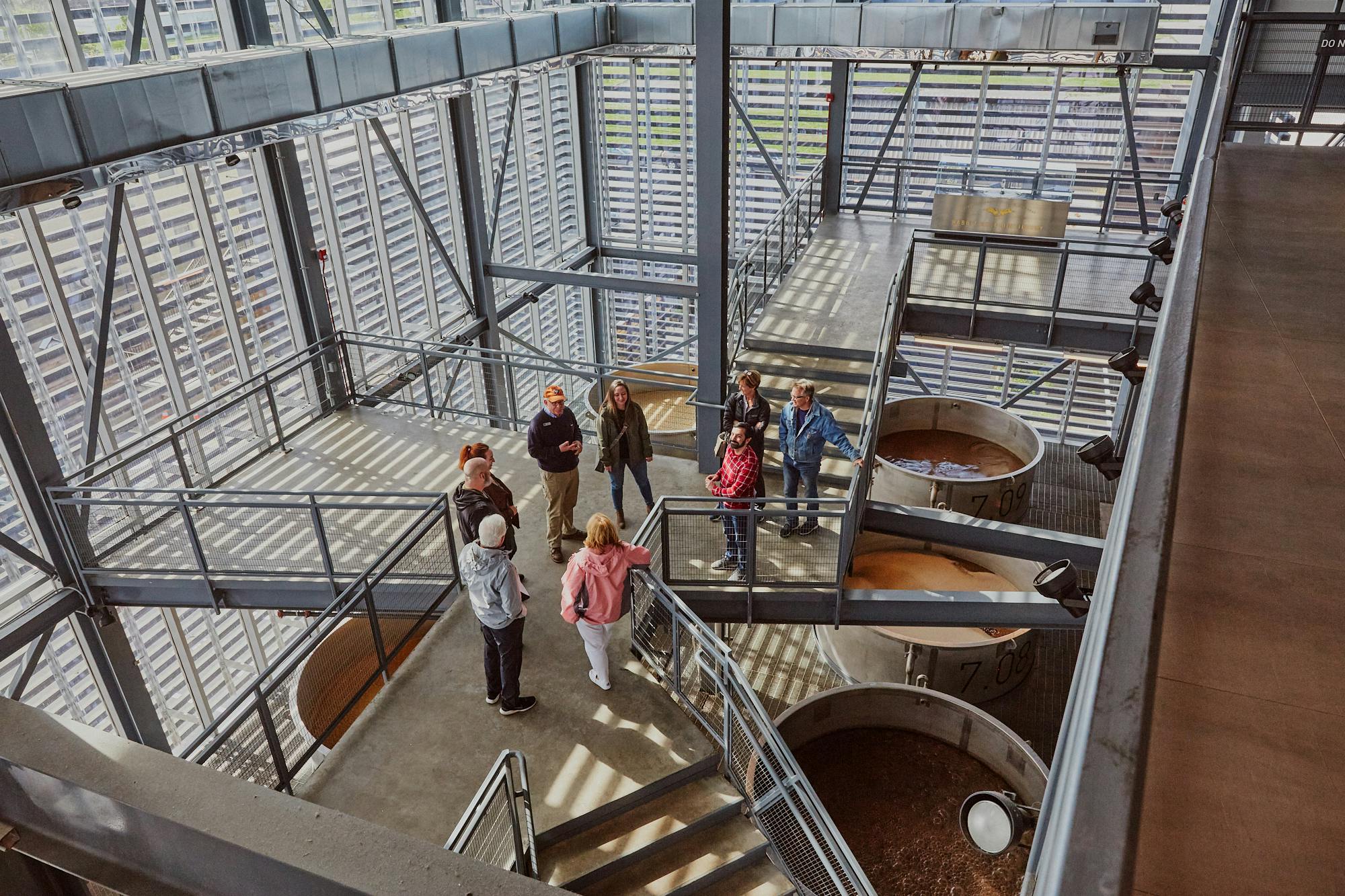 A Mint Julep Experiences Tour group listens to a tour guide at Rabbit Hole Distillery