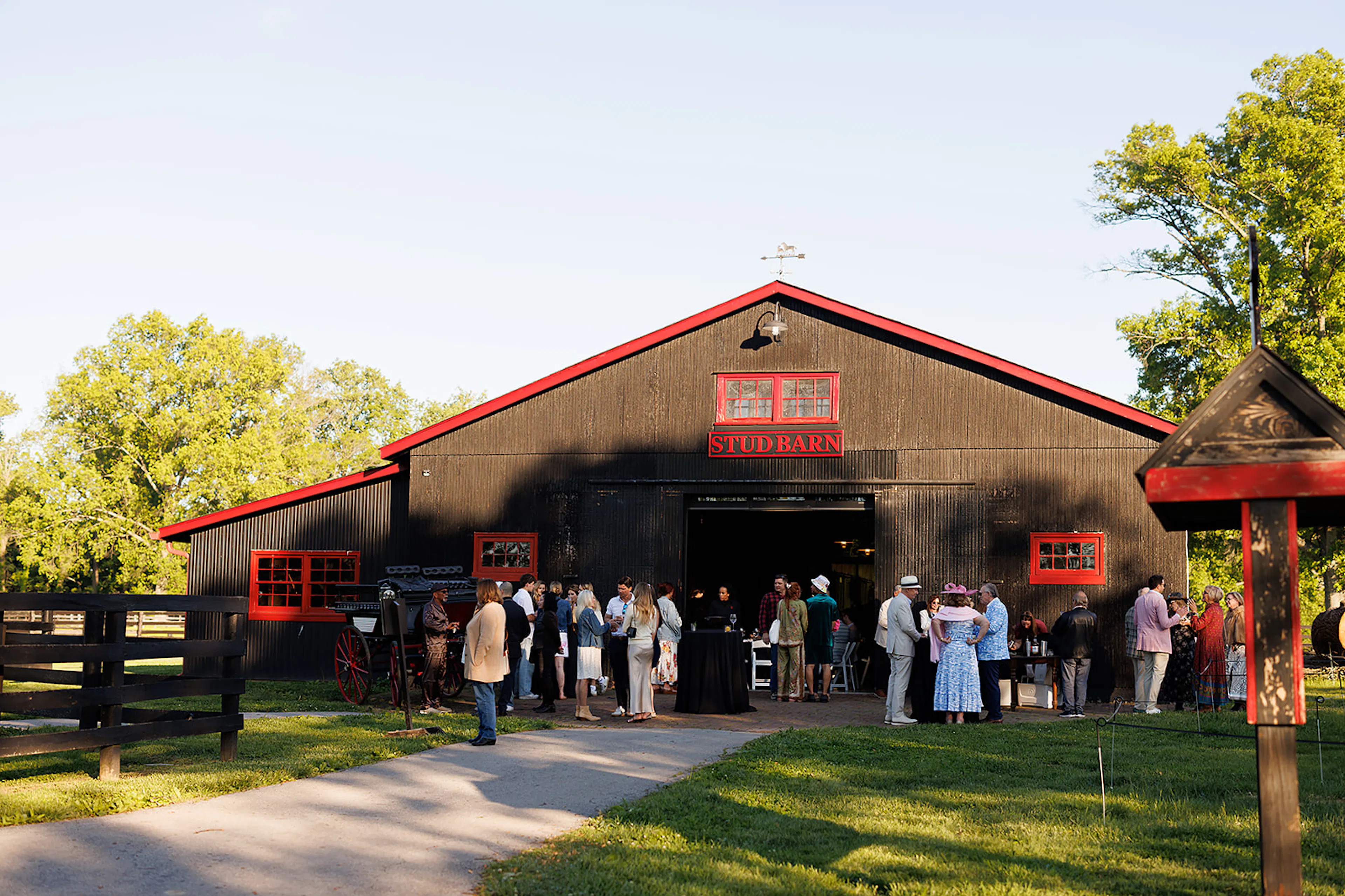 A photo of the sunset social derby party taking place in the red and black stud barn at hermitage farm