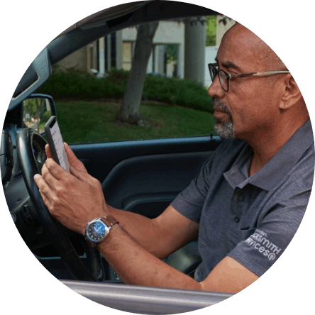 Minute Key auto locksmith in car looking at his cell phone