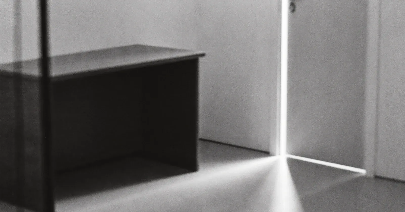 An emptied executive office, preparing a business transition, contemplative black and white