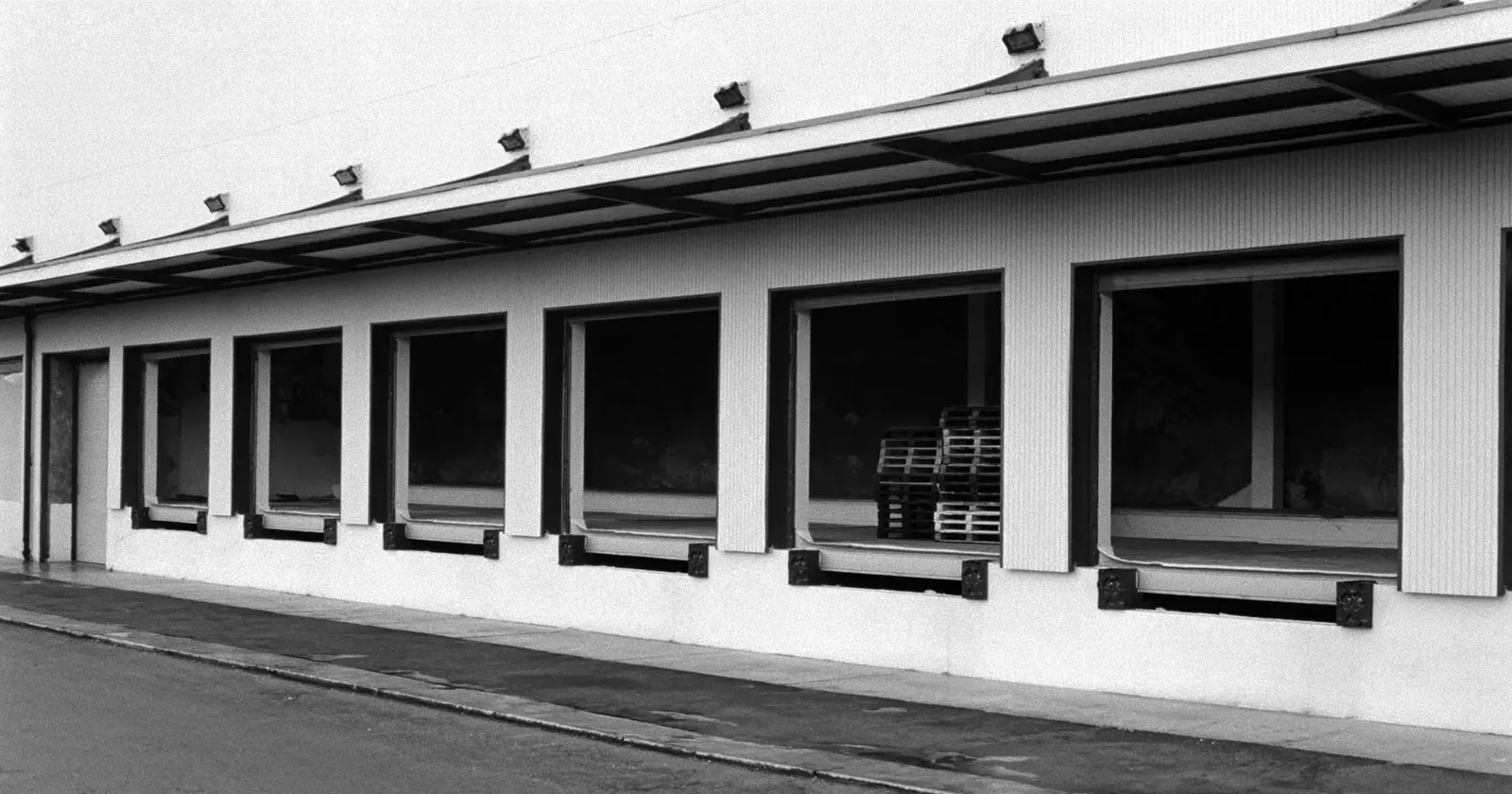 A loading bay where one bay of many is filled, customer concentration risk, contemplative black and white