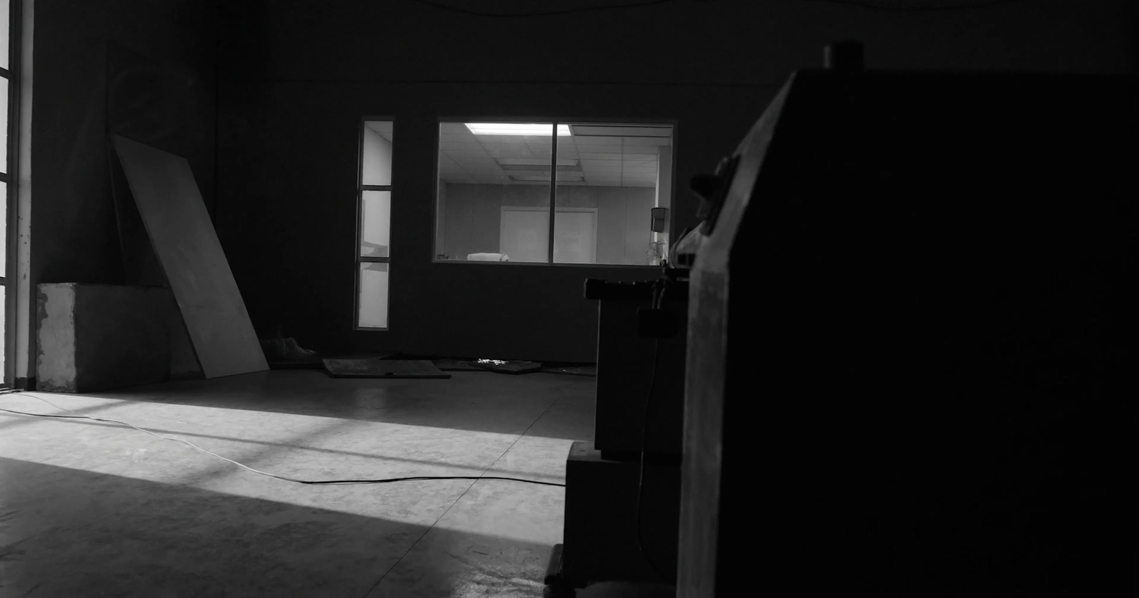 Industrial workshop at end of day, SME operational dependency, contemplative black and white