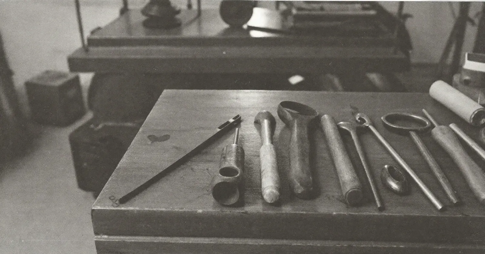 Tools laid on a workbench seen from the operator post, operator or advisor, embodied approach, contemplative black and white