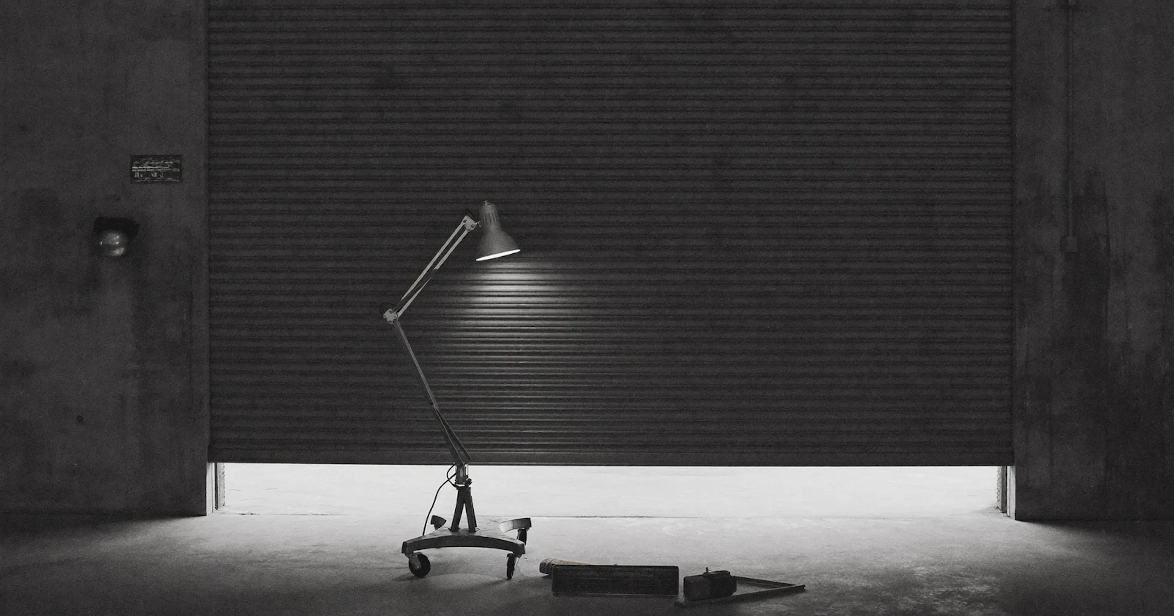 A workshop door closing, loss of a major client, contemplative black and white