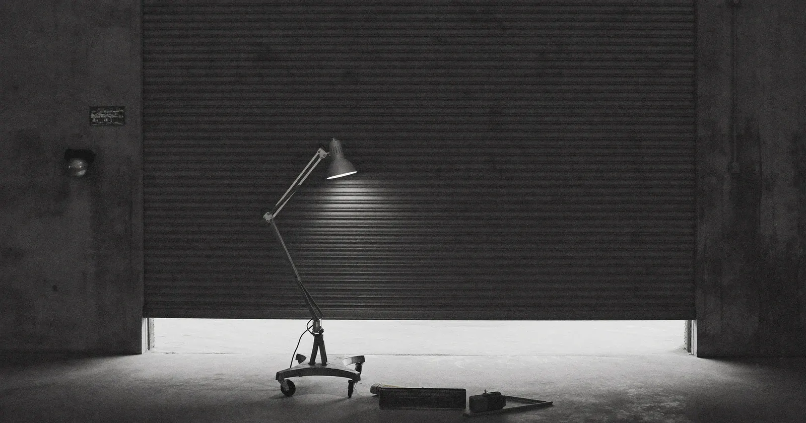 A workshop door closing, loss of a major client, contemplative black and white