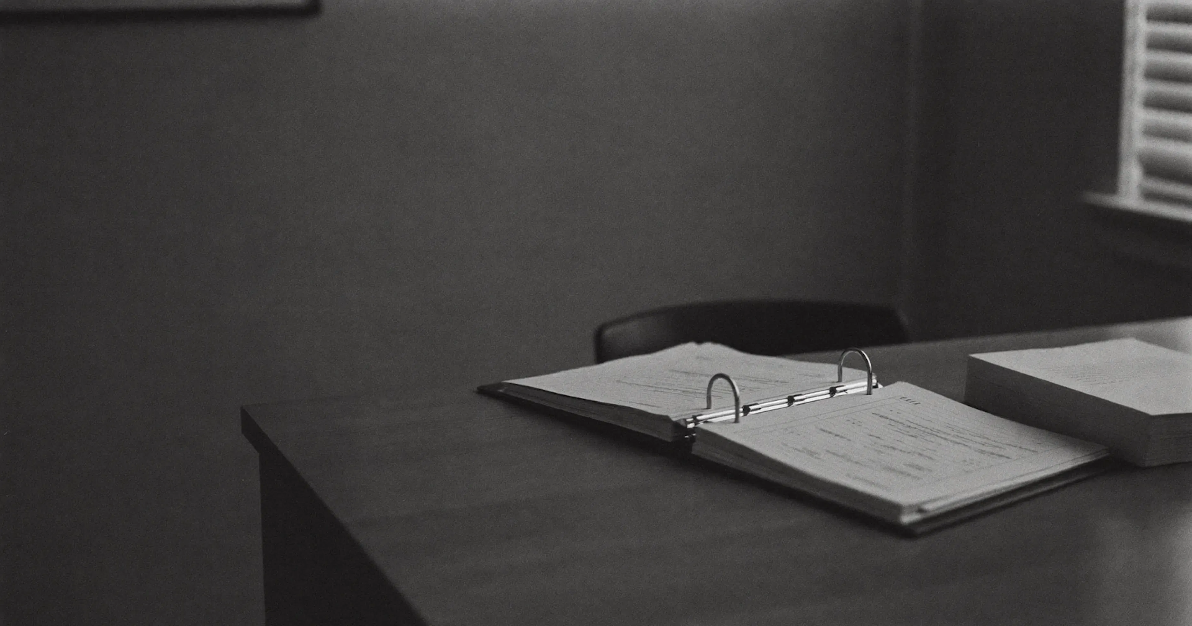 Half-open binder in an accounting office, reliability of internal numbers, black and white