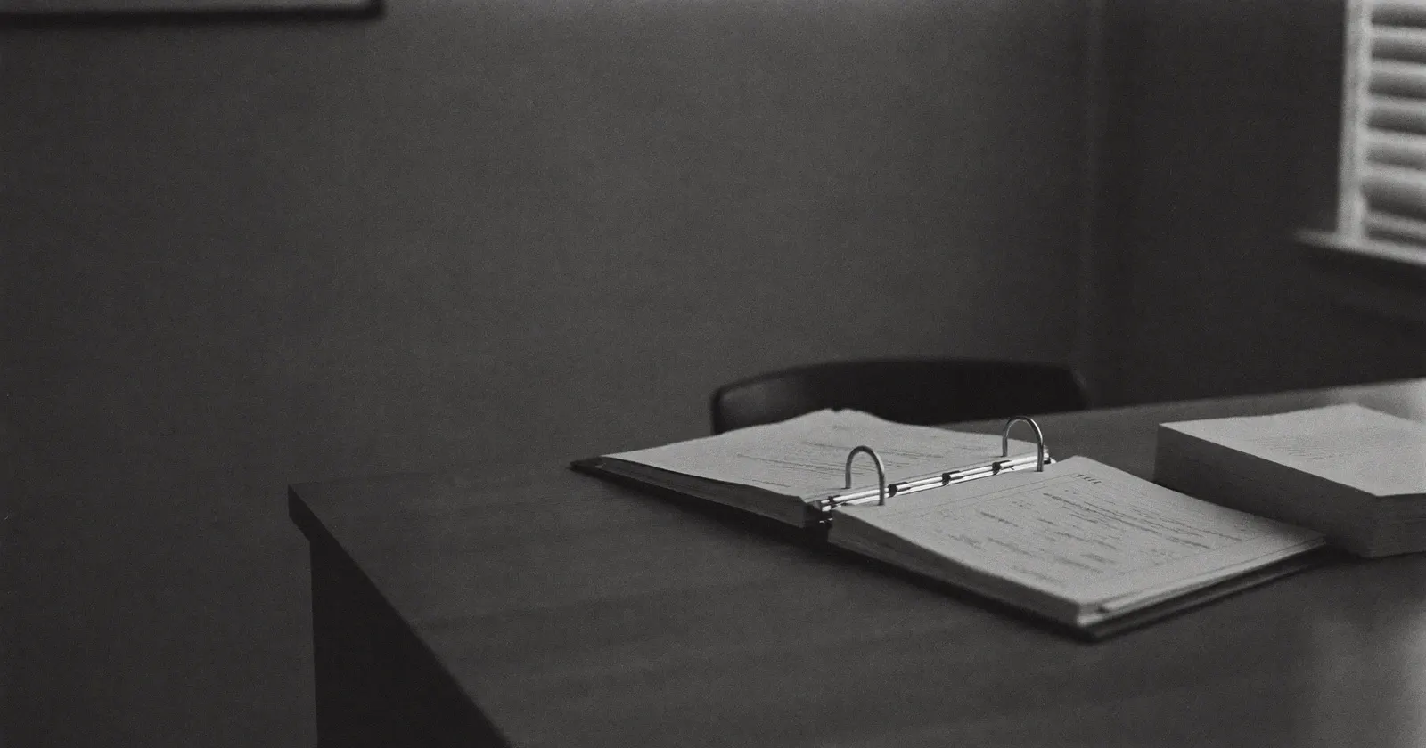 Half-open binder in an accounting office, reliability of internal numbers, black and white