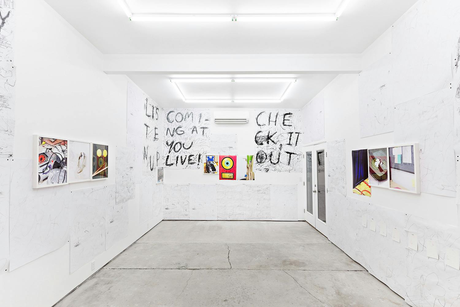 Installation shot of "A Concert" at Arcade On Stadium. Large white room with photographs and posters on the wall.