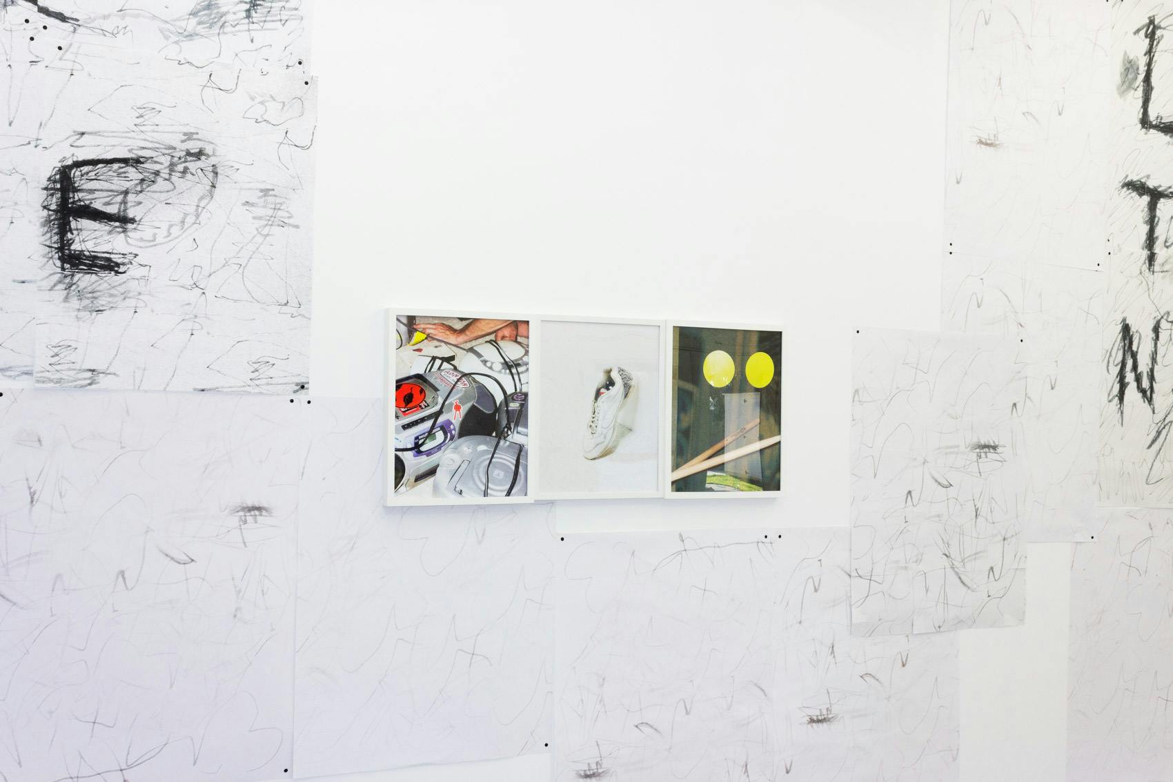 Installation shot of "A Concert" at Arcade On Stadium. Large white room with photographs and posters on the wall.