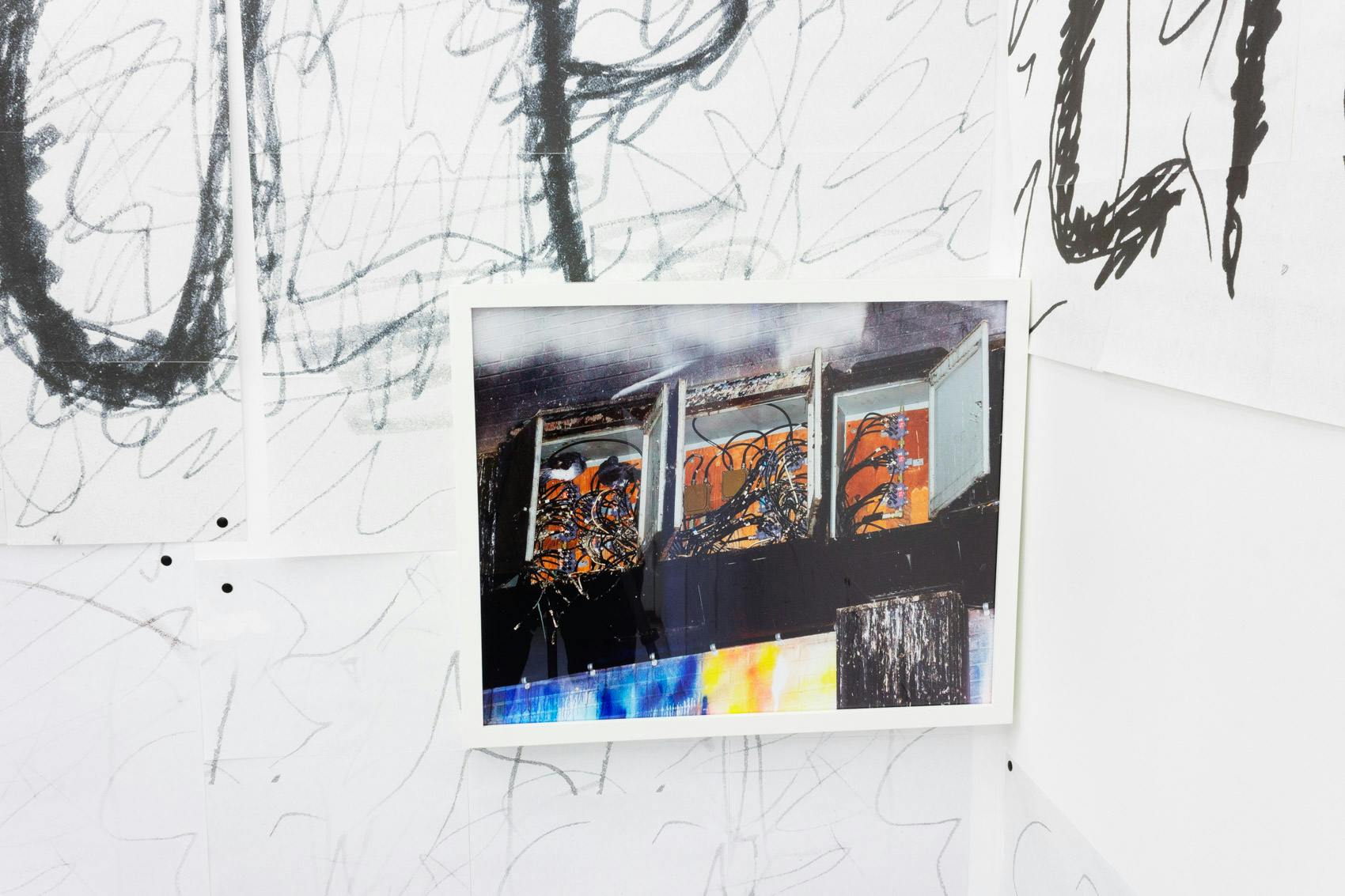 Installation shot of "A Concert" at Arcade On Stadium. Large white room with photographs and posters on the wall.
