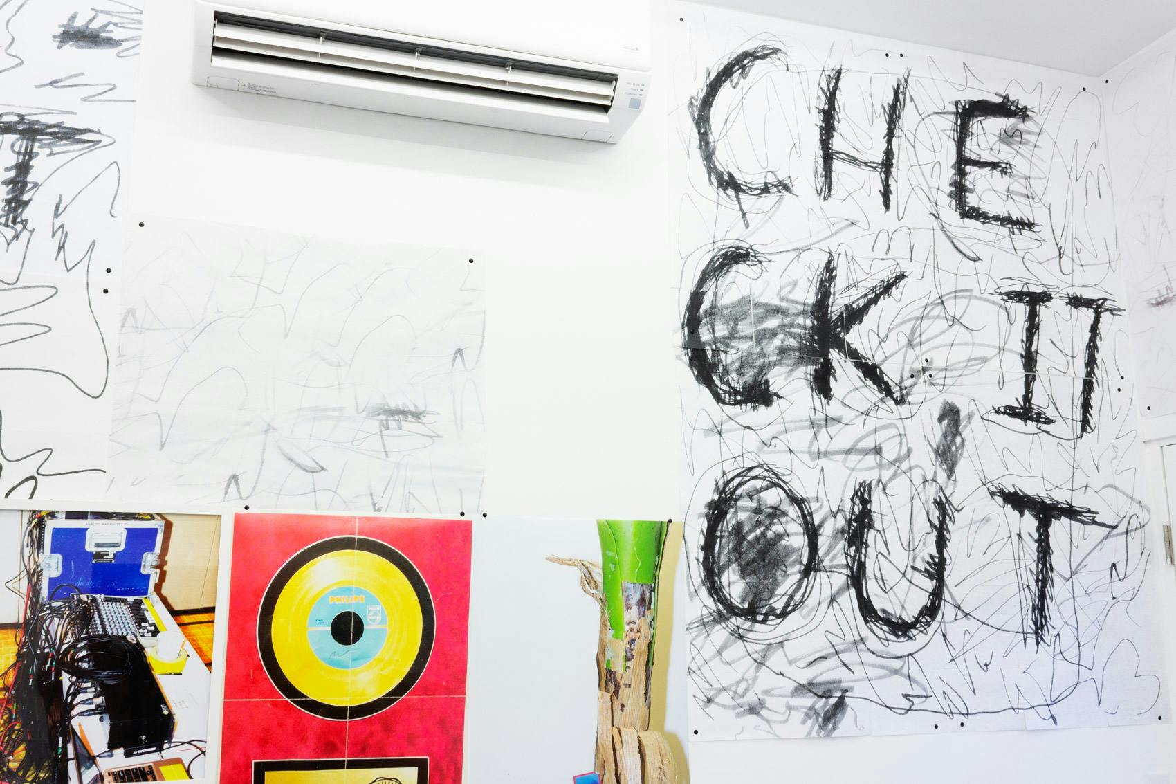 Installation shot of "A Concert" at Arcade On Stadium. Large white room with photographs and posters on the wall.