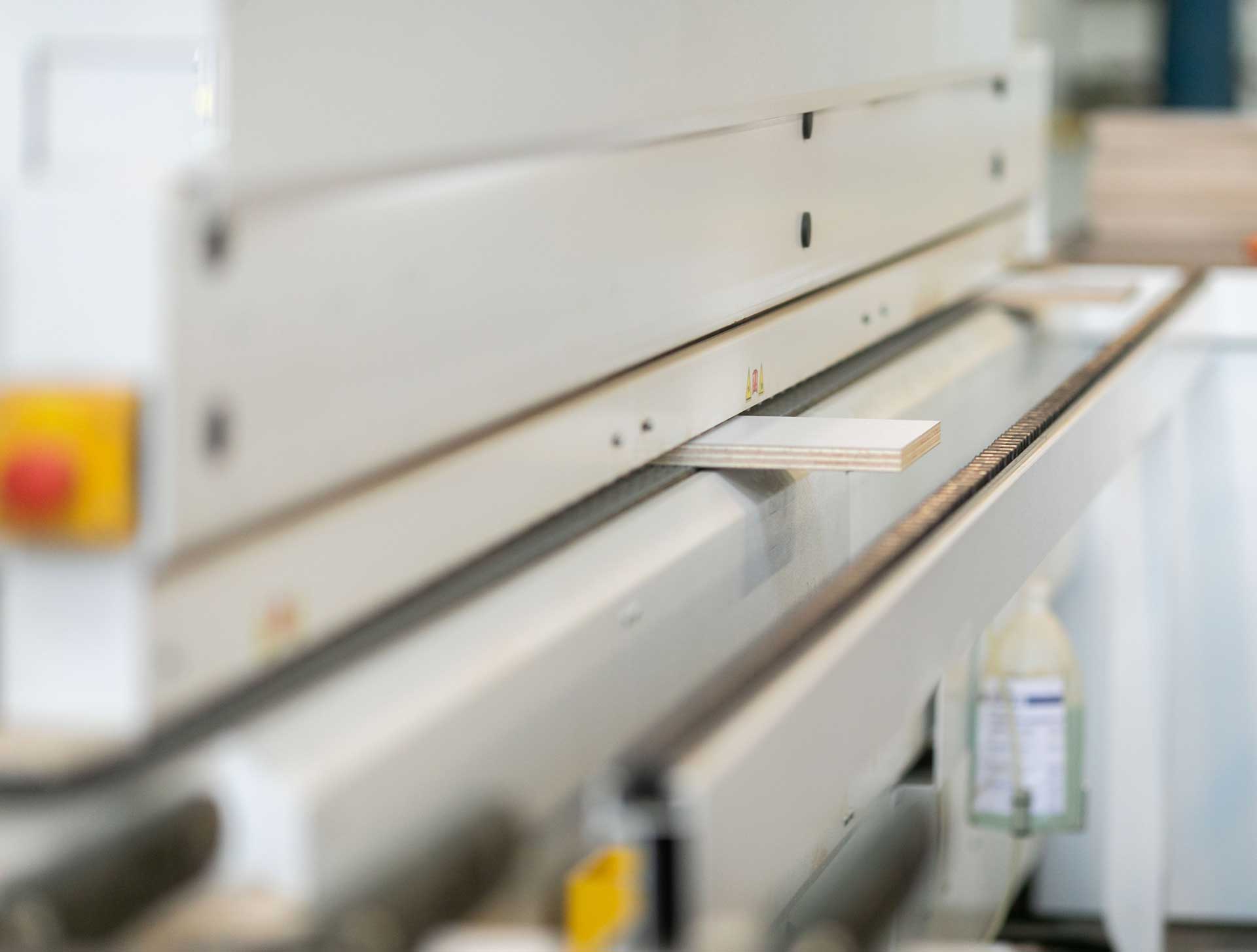 Equipment in use in the wood machine shop. Machine with a bit of wood ready to worked. 